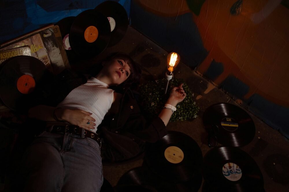 Alternative woman lays on the floor listening to her favorite goth bands.